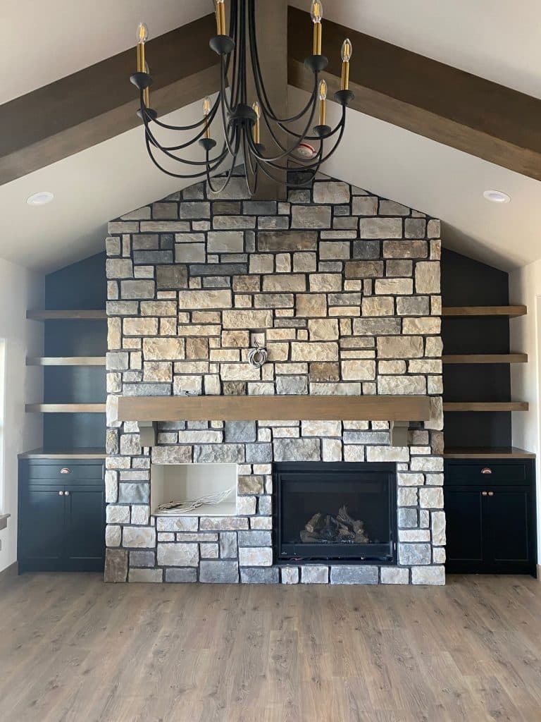 Large natural stone fireplace with vaulted ceiling