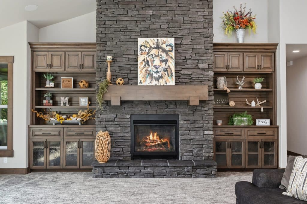 Dark stone fireplace with lots of shelves