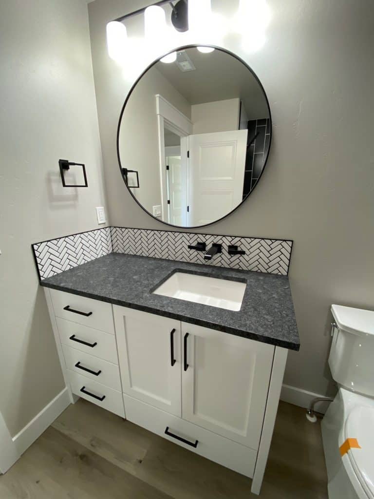 Bathroom with large round mirror