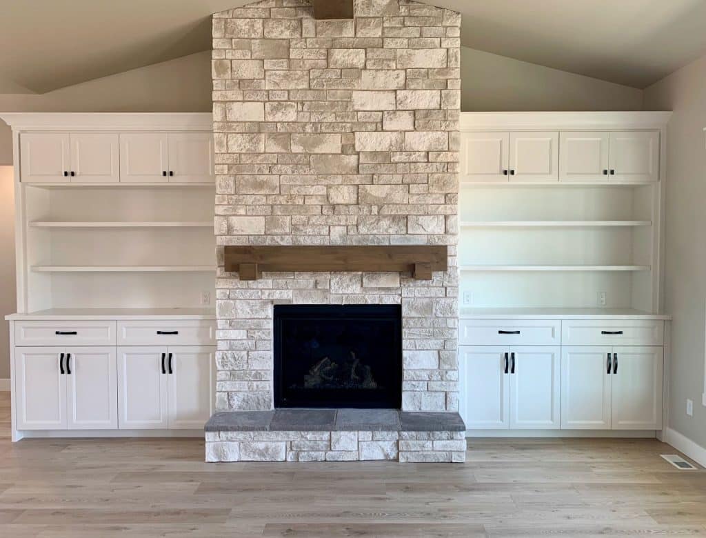 Light natural stone fireplace with empty shelves